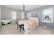 Bedroom with a queen-sized bed, chandelier, and two windows at 1026 Wellesley Crest Dr, Woodstock, GA 30189