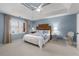 Comfortable bedroom with light blue walls, a bed, and natural light at 1026 Wellesley Crest Dr, Woodstock, GA 30189