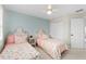 Bedroom with two twin-sized beds, light blue accent wall, and closet at 1026 Wellesley Crest Dr, Woodstock, GA 30189