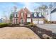 Beautiful brick home with a well-manicured lawn and three-car garage, offering curb appeal at 1026 Wellesley Crest Dr, Woodstock, GA 30189