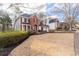 Stunning home with a manicured lawn, three-car garage, and classic brick facade at 1026 Wellesley Crest Dr, Woodstock, GA 30189
