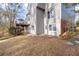 The house has a covered deck, backyard access, and a well-kept lawn at 1026 Wellesley Crest Dr, Woodstock, GA 30189