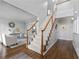 Elegant foyer with hardwood floors, a staircase, and views into the living room at 1026 Wellesley Crest Dr, Woodstock, GA 30189