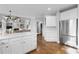 Spacious open kitchen with stainless steel appliances, white cabinets, and hardwood floors at 1026 Wellesley Crest Dr, Woodstock, GA 30189