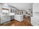 Bright open kitchen with stainless steel appliances, white cabinetry, and hardwood floors at 1026 Wellesley Crest Dr, Woodstock, GA 30189