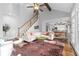 Well-lit living room with hardwood floors, a staircase, an elevated ceiling, and great flow at 1026 Wellesley Crest Dr, Woodstock, GA 30189