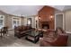 Comfortable lounge area featuring leather sofas, a coffee table, and a brick fireplace at 1026 Wellesley Crest Dr, Woodstock, GA 30189