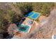 Aerial view of pool, pool house, parking, and tennis courts surrounded by tall trees at 3410 Kates Way, Duluth, GA 30097