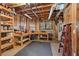 Workshop in basement with wood paneled walls and storage and work spaces at 3410 Kates Way, Duluth, GA 30097
