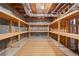 Unfinished basement with exposed rafters and shelving for storage at 3410 Kates Way, Duluth, GA 30097