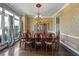 Traditional dining room with hardwood floors, large window, and chandelier at 3410 Kates Way, Duluth, GA 30097