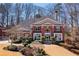 Stately brick home with a manicured front lawn and mature trees at 3410 Kates Way, Duluth, GA 30097
