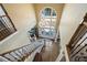 Grand foyer featuring a large window, chandelier, hardwood floors, and a curved staircase at 3410 Kates Way, Duluth, GA 30097