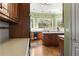 Spacious kitchen with hardwood floors, a center island, and a large window overlooking trees at 3410 Kates Way, Duluth, GA 30097