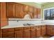 Traditional kitchen showcasing wood cabinets, a white countertop, and a tiled backsplash at 3410 Kates Way, Duluth, GA 30097
