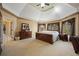 Luxurious main bedroom with a tray ceiling, carpet, and large windows with wooded views at 3410 Kates Way, Duluth, GA 30097
