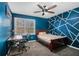 Stylized bedroom with blue accent wall, desk, and a window providing natural light at 146 Crowell Se Rd, Conyers, GA 30094