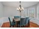 Formal dining room featuring hardwood floors, elegant chandelier, and beautiful window shutters at 146 Crowell Se Rd, Conyers, GA 30094