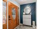 Entryway featuring a decorative wooden door, stylish blue accent wall, and decorative shelf at 146 Crowell Se Rd, Conyers, GA 30094