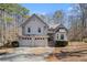 Charming two-story home with a three-car garage and well-maintained landscaping surrounded by mature trees at 146 Crowell Se Rd, Conyers, GA 30094