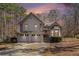 Charming two-story home with a three-car garage and well-maintained landscaping in a wooded setting at 146 Crowell Se Rd, Conyers, GA 30094
