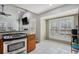 Bright eat-in kitchen area featuring white tile flooring and stainless steel appliances at 146 Crowell Se Rd, Conyers, GA 30094