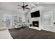 Living room with fireplace, vaulted ceilings, ceiling fan, and ample natural light at 146 Crowell Se Rd, Conyers, GA 30094