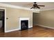 Inviting living room featuring a classic fireplace, hardwood floors, and a ceiling fan at 1867 Dresden Dr, Atlanta, GA 30319