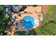 Aerial view of the in-ground pool and wooden deck area, complete with outdoor seating and landscaping at 2287 Lake Ridge Ter, Lawrenceville, GA 30043