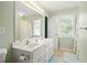 Bright bathroom with double vanity, and a separate toilet and shower area at 2287 Lake Ridge Ter, Lawrenceville, GA 30043