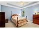 Charming bedroom with a four-poster bed, natural light, and neutral decor at 2287 Lake Ridge Ter, Lawrenceville, GA 30043