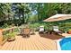 Spacious outdoor deck featuring a dining set, lounge chairs, and beautiful pool view for relaxing and entertaining at 2287 Lake Ridge Ter, Lawrenceville, GA 30043