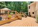 Outdoor deck with stairs, a patio umbrella, and a view of the surrounding trees, perfect for entertaining at 2287 Lake Ridge Ter, Lawrenceville, GA 30043