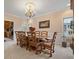 Spacious dining room features a wooden dining table, chandelier and large windows at 2287 Lake Ridge Ter, Lawrenceville, GA 30043
