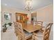 Bright dining room with an expansive wooden table, upholstered chairs, and a wooden china cabinet at 2287 Lake Ridge Ter, Lawrenceville, GA 30043