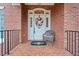 Charming front entrance with a decorative wreath, chair, and brick facade at 2287 Lake Ridge Ter, Lawrenceville, GA 30043