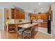 Well-equipped kitchen featuring wood cabinets, an island with bar seating, and modern appliances at 2287 Lake Ridge Ter, Lawrenceville, GA 30043