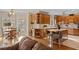 Open-concept kitchen featuring wood cabinets, an island with bar seating, and an adjacent dining area at 2287 Lake Ridge Ter, Lawrenceville, GA 30043