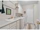 Bright laundry room with cabinets, sink, washer and dryer and door to the exterior at 2287 Lake Ridge Ter, Lawrenceville, GA 30043