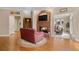 Comfortable living room with fireplace, hardwood floors, and access to other areas of the home at 2287 Lake Ridge Ter, Lawrenceville, GA 30043