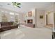 Cozy living room features fireplace, large windows and a comfortable brown couch at 2287 Lake Ridge Ter, Lawrenceville, GA 30043