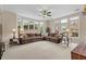 Open living room with plush sectional sofa, large windows, and views of the backyard at 2287 Lake Ridge Ter, Lawrenceville, GA 30043