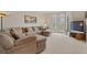 Cozy living room with bay windows, a large sectional sofa, and entertainment center at 2287 Lake Ridge Ter, Lawrenceville, GA 30043