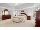 This spacious bedroom features light walls, carpet and matching furniture at 2287 Lake Ridge Ter, Lawrenceville, GA 30043
