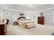 The bedroom has neutral walls, carpet, a large window, and matching furniture at 2287 Lake Ridge Ter, Lawrenceville, GA 30043