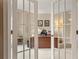 Elegant home office viewed through glass French doors, featuring built-in desk at 2287 Lake Ridge Ter, Lawrenceville, GA 30043