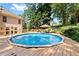 Backyard showcases a large, above-ground pool with an expansive deck for lounging and soaking up the sun at 2287 Lake Ridge Ter, Lawrenceville, GA 30043