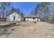 Rear view of home, highlighting the expansive backyard with mature trees at 627 Rock Springs Rd, Lawrenceville, GA 30043