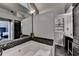 Elegant bathroom featuring a soaking tub, tile accents, and access to the main bedroom and vanity at 627 Rock Springs Rd, Lawrenceville, GA 30043
