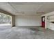 Spacious two car garage area with red door and storage shelves at 627 Rock Springs Rd, Lawrenceville, GA 30043